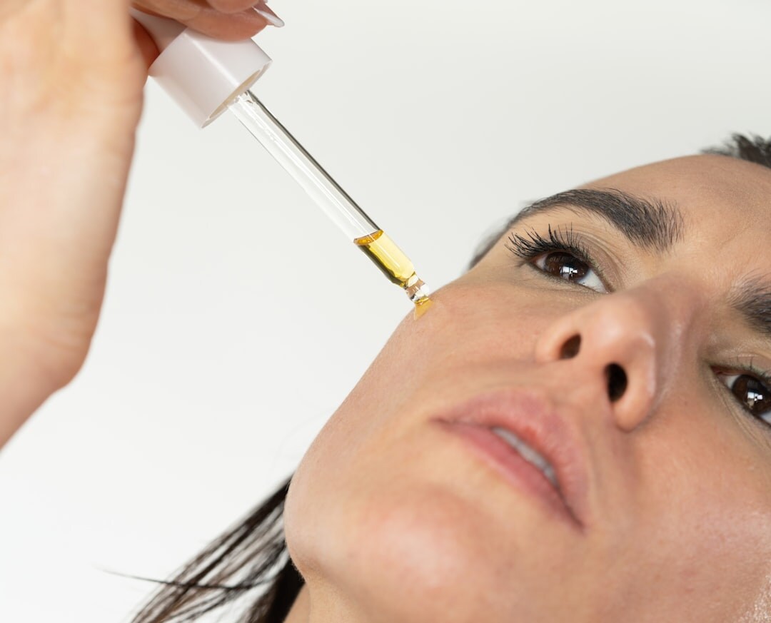 woman applying facial serum
